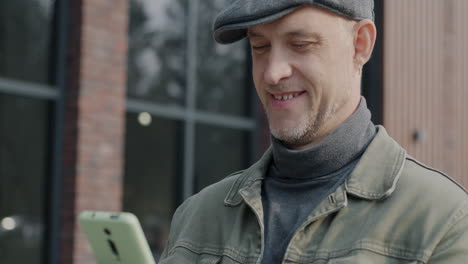 man looking at his smartphone outdoors