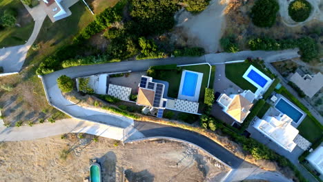 Top down drone shot rotating above a solar powered house, sunset in Greece