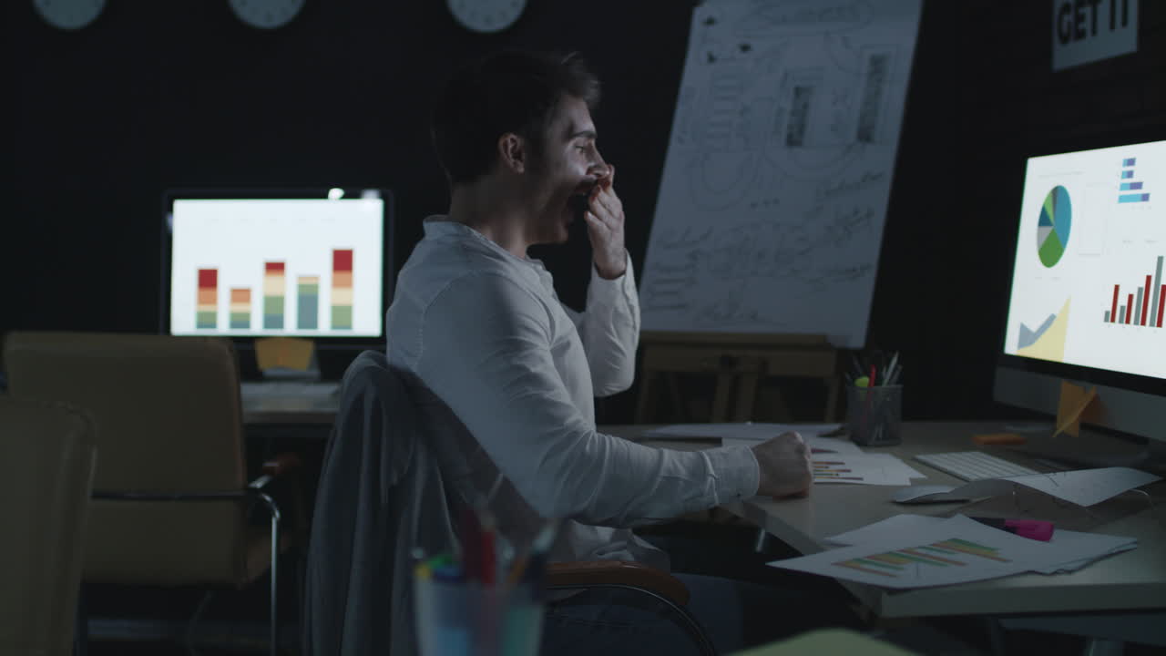 Fatigue business analyst sleeping on table front computer screen in night office