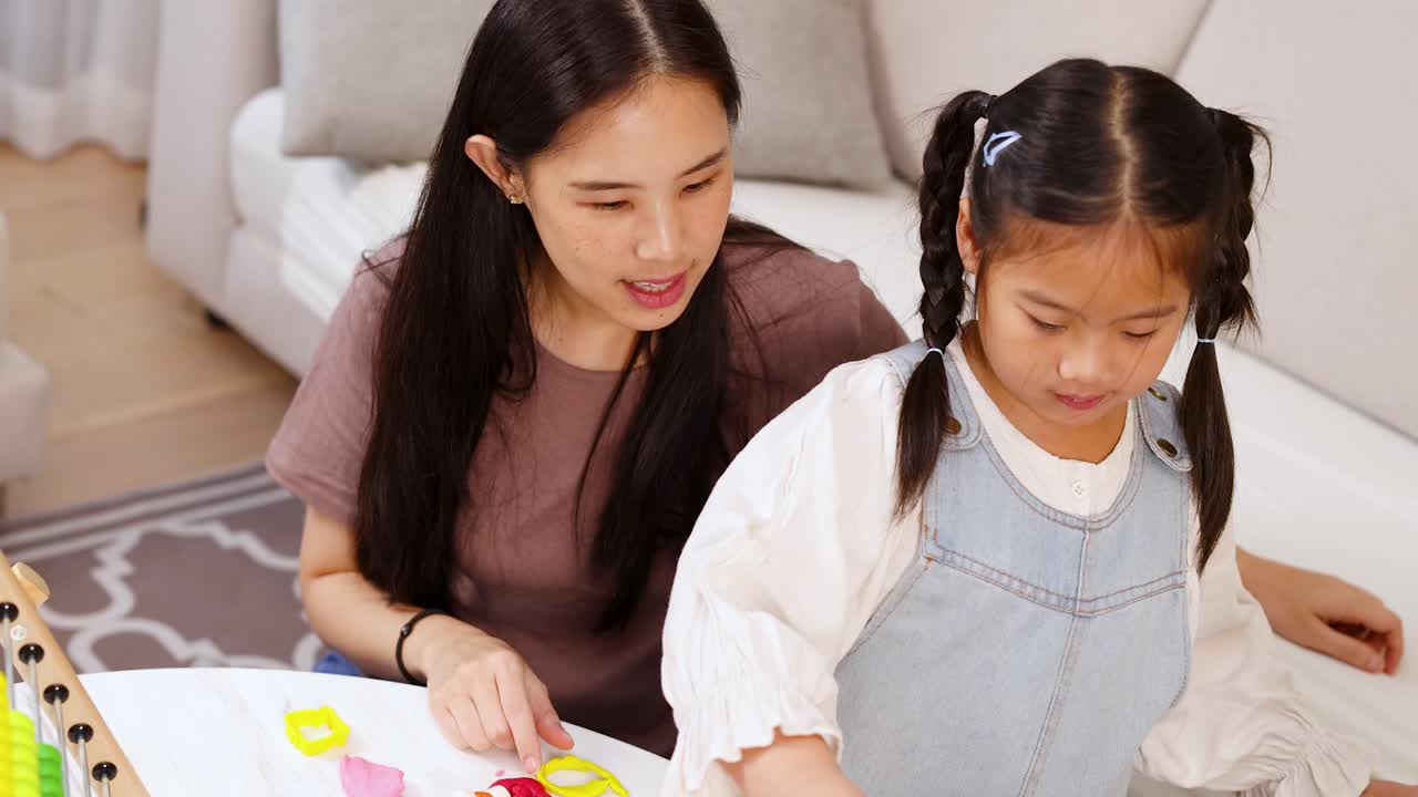 Mother and daughter playing together indoors