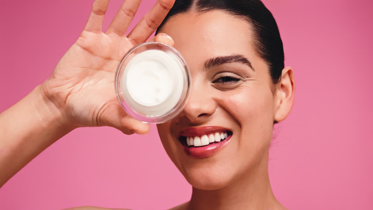 Smiling woman with skincare cream