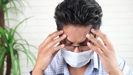 man with headache and mask