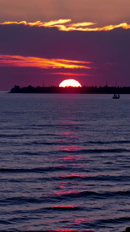 dramatic ocean sunset with distant horizon and boat
