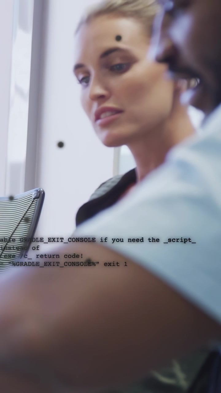 Vertical video: Woman dev speaking, causing code overlay while man dev typing, debugging tech