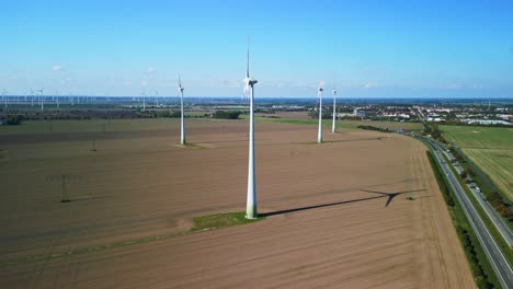 wind farm from the side long shadow on field