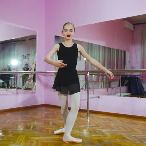 ballerina dancing in studio in front of mirror. in the ballet hall. a little dancer. slow motion.