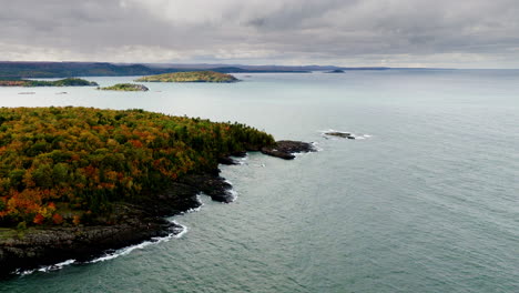 drone shot flying over park in northern michigan in full fall colors