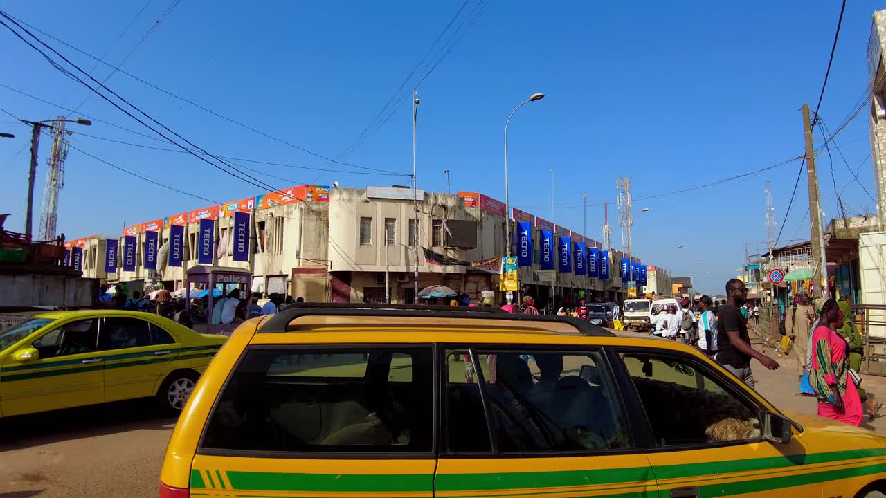 Busy intersection close to the Serekunda Market, golden hour in Gambia, Africa
