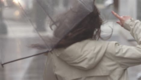 young beautiful latin woman dancing around with an umbrella in the city while listening to music. she then walks out of frame