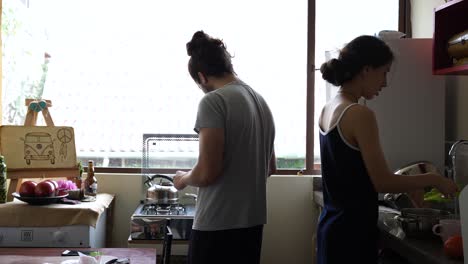 young couple prepare breakfast together in the morning and in pajamas