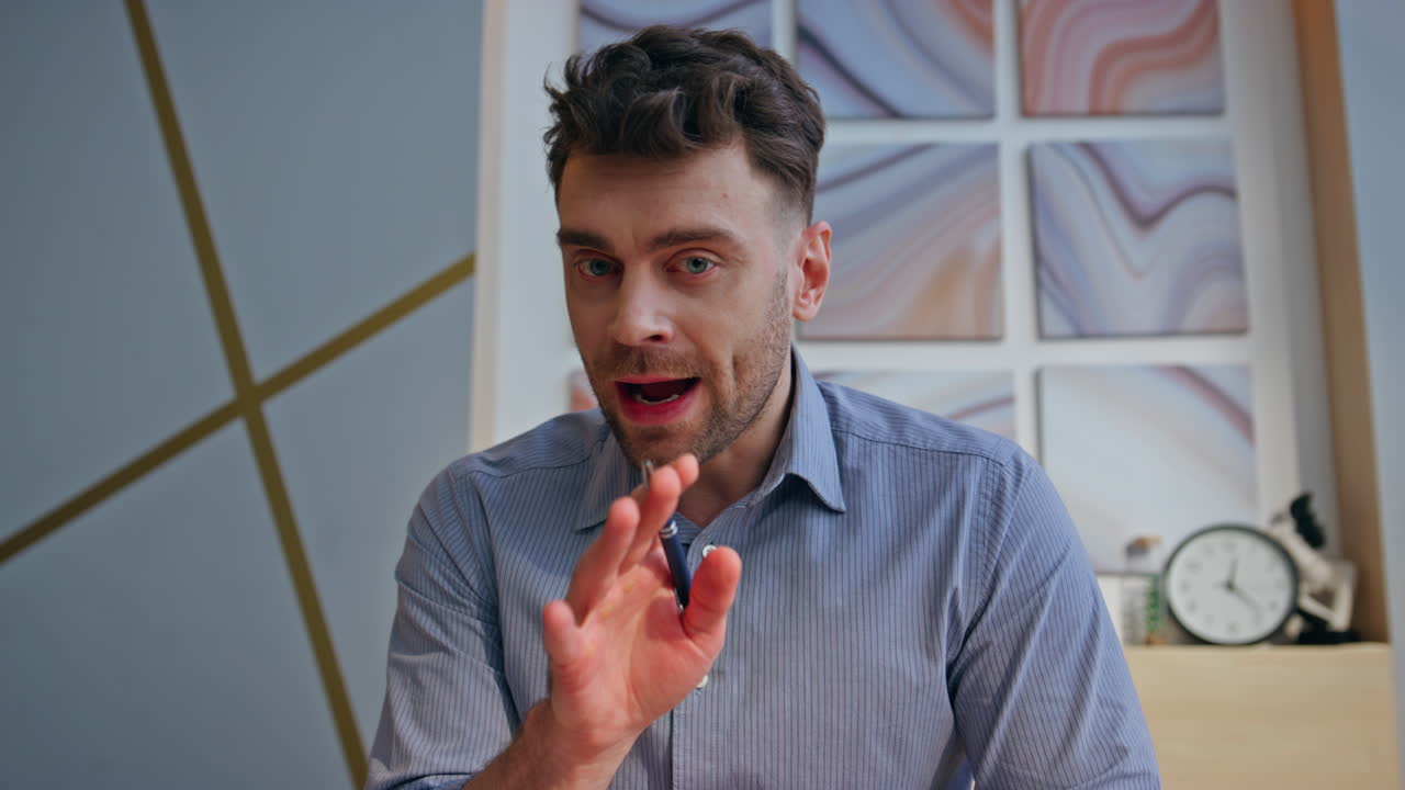 Angry boss videocalling remotely at office pov portrait. Stressed man arguing