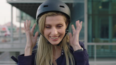 attractive young blonde woman portrait of cute business intern wearing safety helmet looking silly playful in city