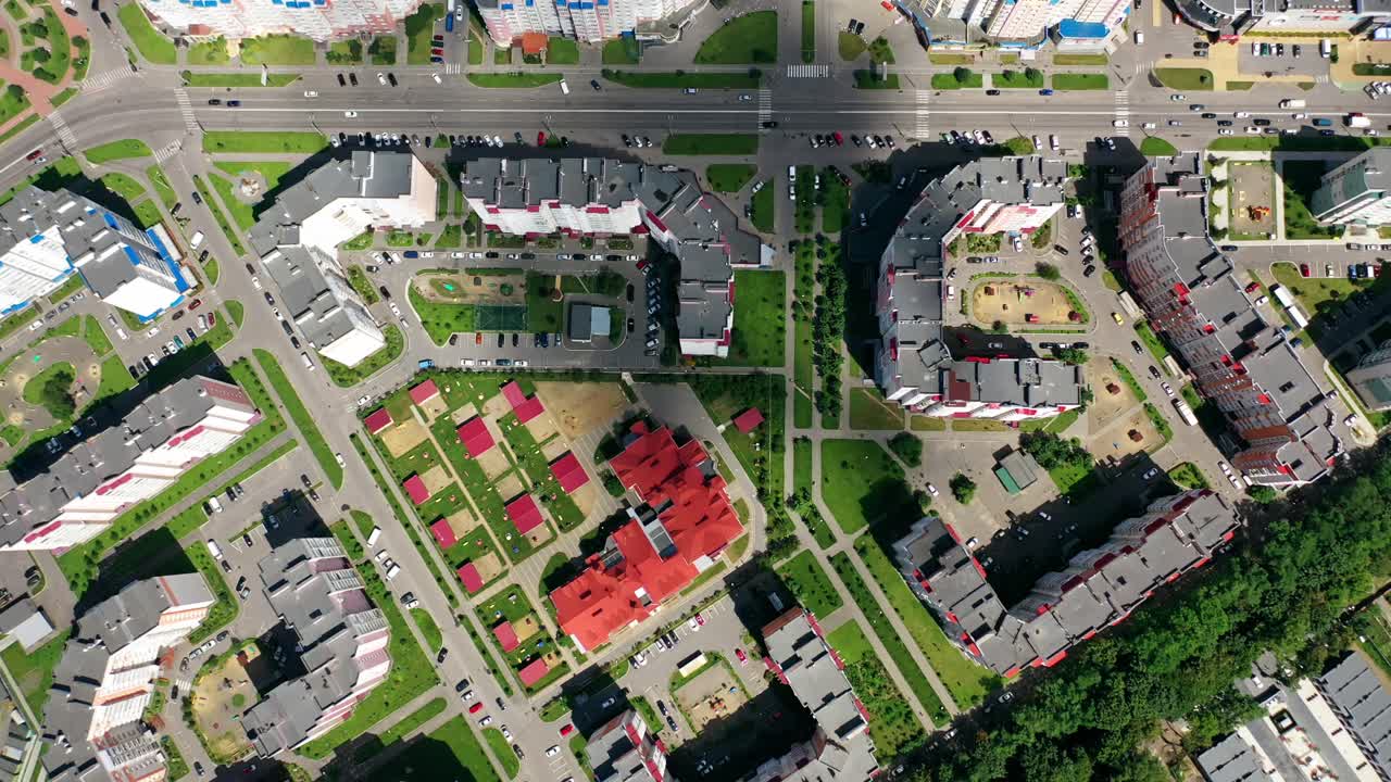 Cityscape from above. Modern downtown. Rooftops of architectural buildings in urban district. Motion camera to the right.