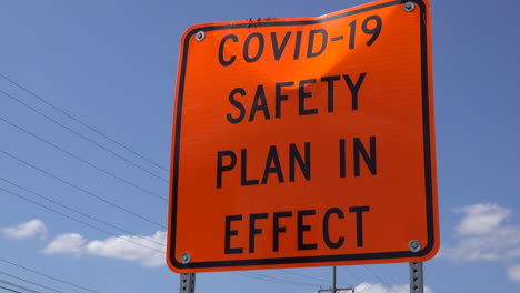Slow zoom-in on a roadside COVID safety sign