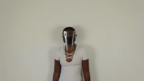 african lady putting on a visor while wearing a mask for covid-19