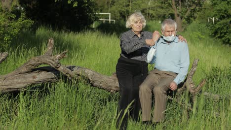 family of grandparents takes off medical masks after coronavirus quarantine end