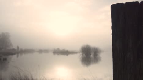 misty sunrise over a frozen lake