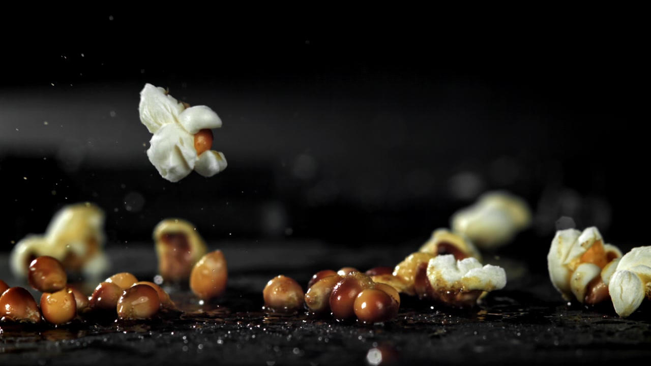 Popcorn Kernel Popping in Slow Motion on a Dark Background