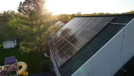 solar panels on sloped shingle roof of american family home