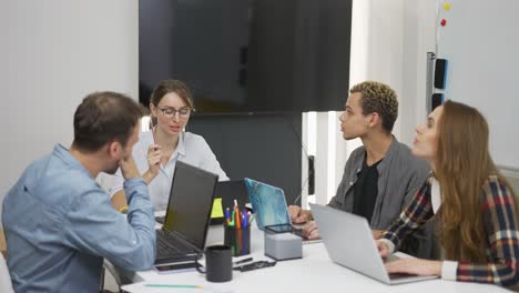 Jóvenes-Empresarios-Creativos-Con-Computadoras-Portátiles-En-La-Oficina