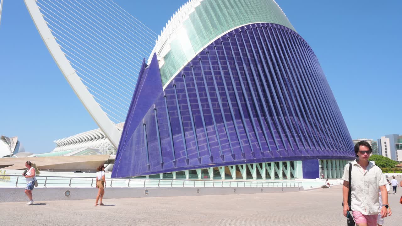 Tilt-down view of the CaixaForum Valencia, Agora, as people visit the City of Arts and Sciences. Designed by Santiago Calatrava, it is the most significant modern tourist destination in Valencia.