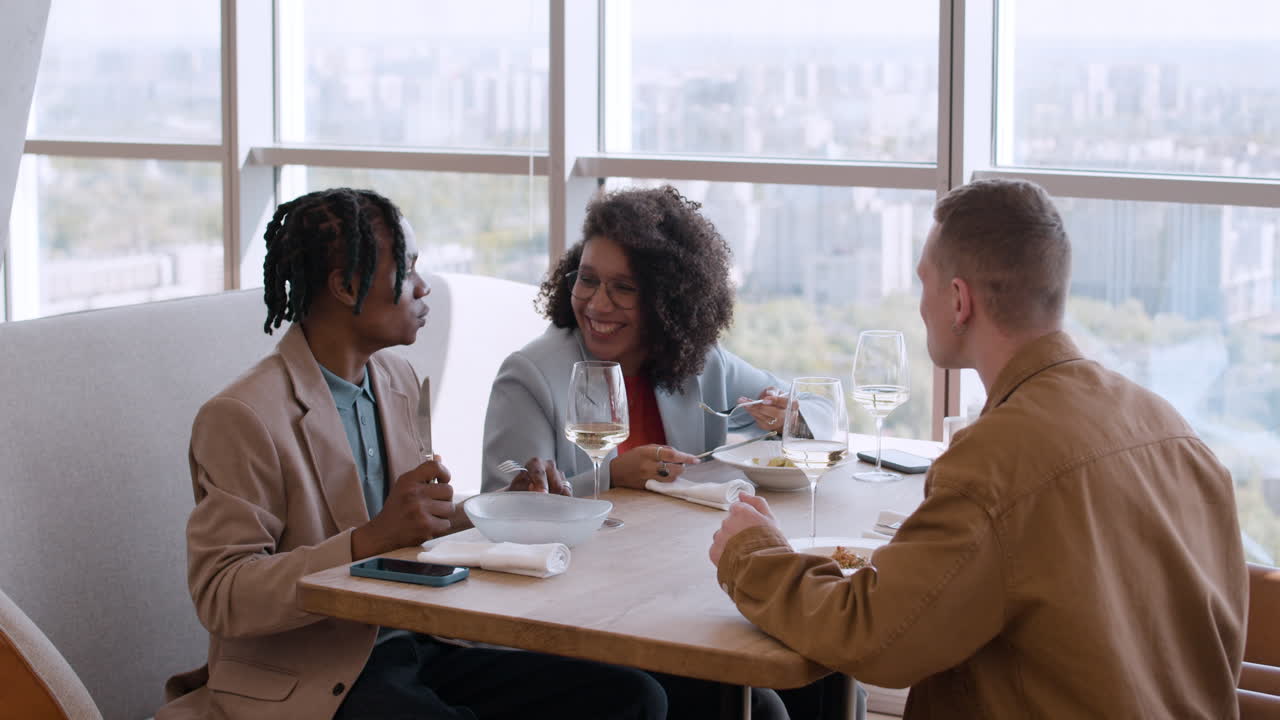 Friends Enjoying Lunch with City View