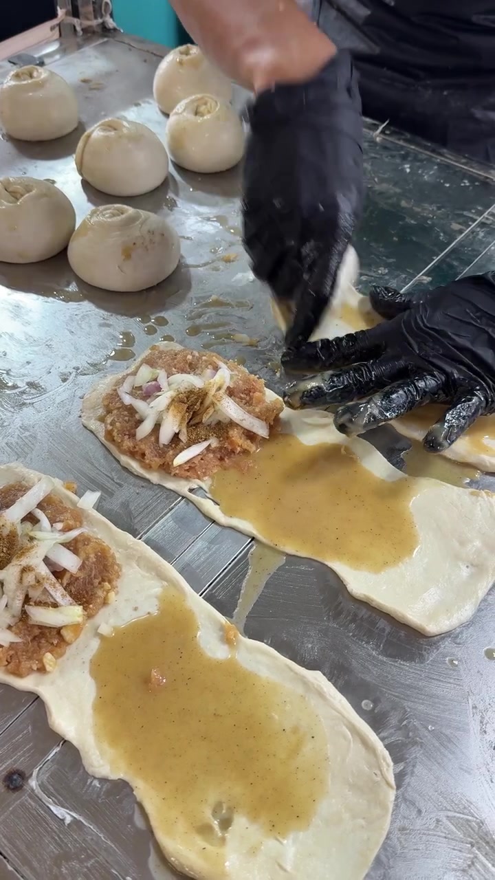 Chef Preparing Traditional Stuffed Dough Pastries in Commercial Kitchen