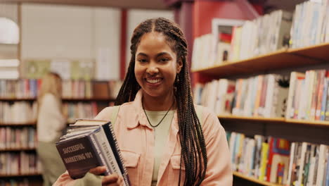 a young woman in a library holding books