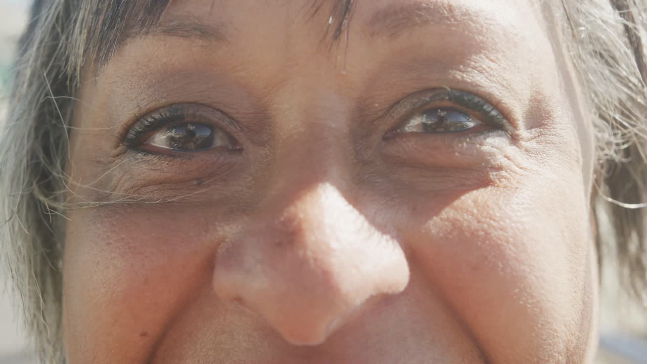 retrato de una feliz anciana afroamericana en un paseo marítimo, en cámara lenta