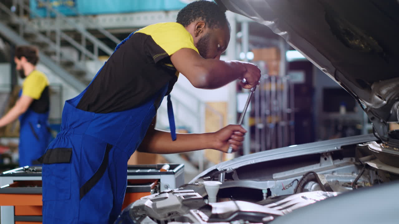 Professional in car service uses wrench
