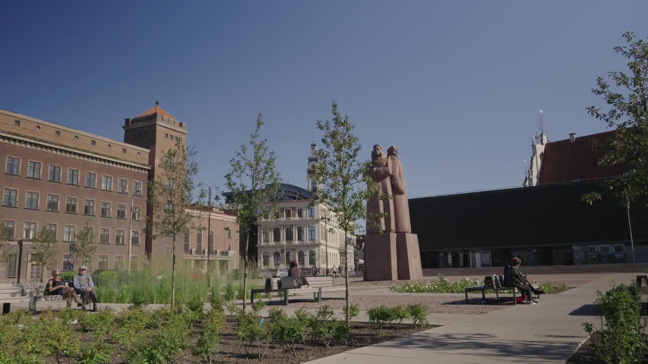 Statue in Riga City Park with St. Peter's Church in the Background