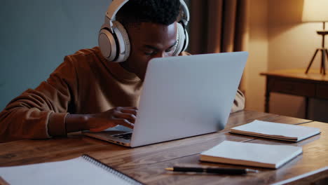 young man studying on laptop