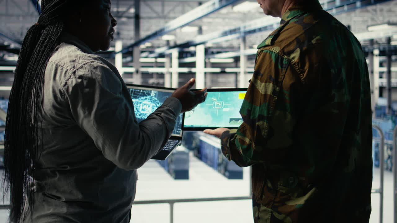 Close Up Of Military Data Center Colleagues Looking At Radar Software
