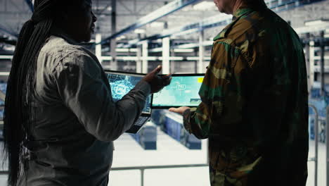 close up of military data center colleagues looking at radar software