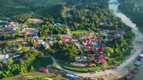 orbit drone shot of kuala tahan, malaysian village at the tembeling river in taman negara national park during the day in peninsular malaysia