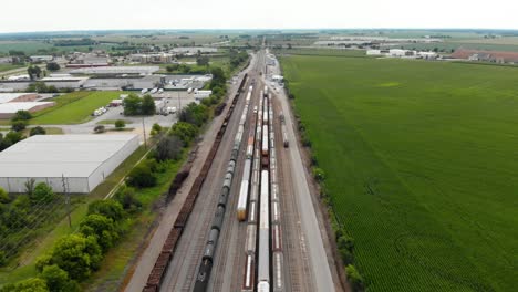 4k aerial view showing multiple trains parked at a train station waiting to leave