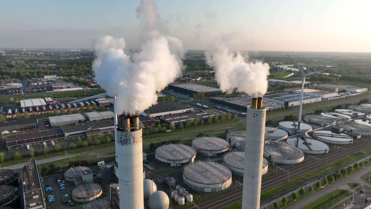 massive waste incinerator, smoke plums, sky view. Aerial drone view. waste incineration plant, sunset.