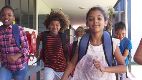 kids running in school hallway, front view, close up