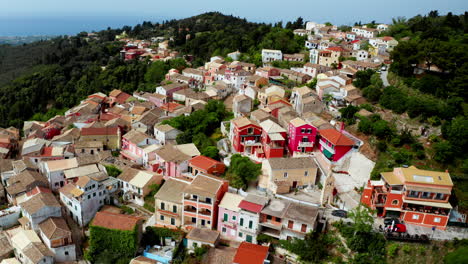 Aerial-drone-shot-over-old-Greek-mountain-village-of-Lakones-in-Corfu-surrounded-in-green-lush-vegetation