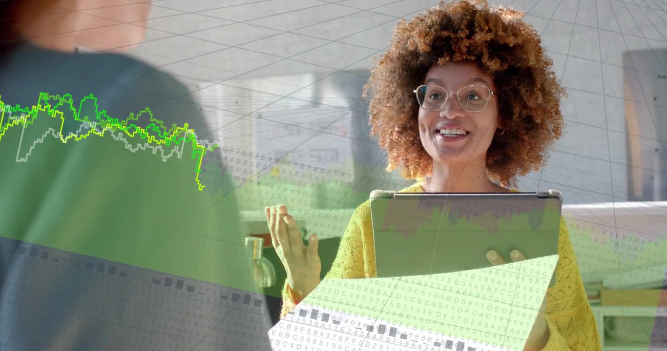Woman lifting hand, showing tablet and sheet, graphs overlaying view and showing tech data to team