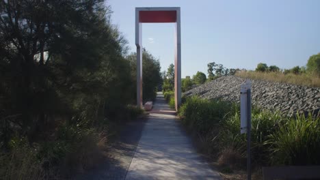 long concrete walkway with trees