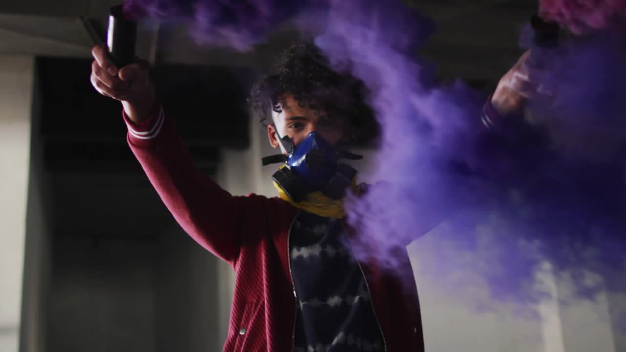 Man lifting arms, firing purple smoke flares in garage, sending rising hearts and likes for social