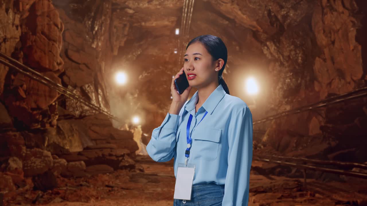 Side View Asian Female In Underground Mine Tunnel, She Pick The Phone Up And Started To Specking To It With A Slicely Smile