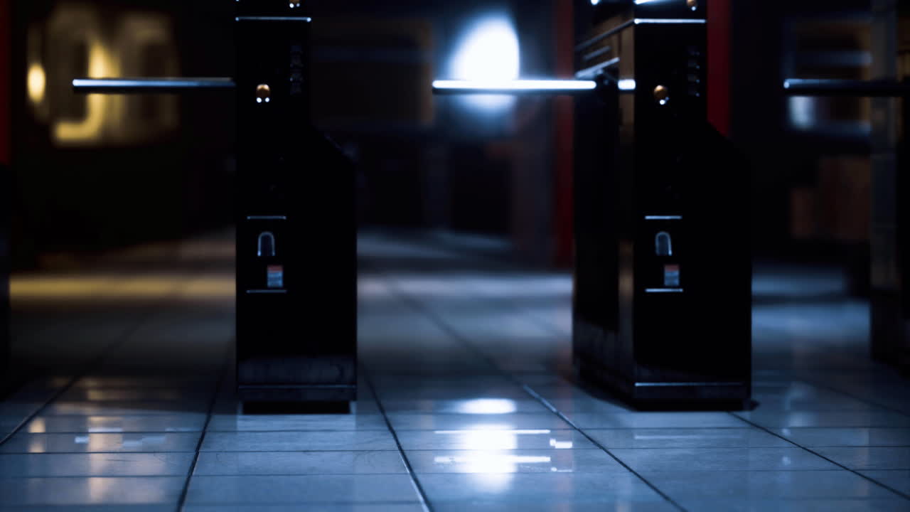Turnstiles at a quiet underground station during late night hours