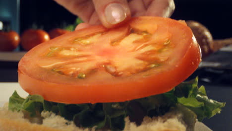 Detail-shot,-preparation-of-ham,-cheese,-lettuce-and-tomato-sandwich