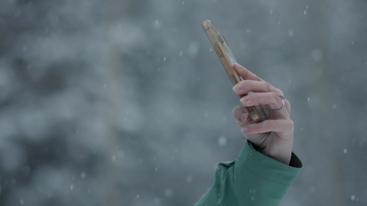 Woman taking a selfie in the snow