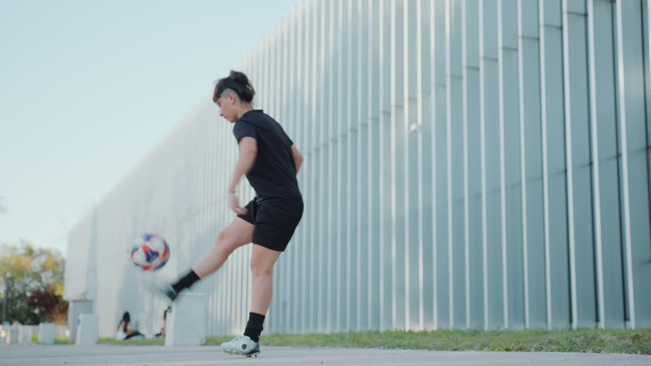 Girl Juggling a Soccer Ball in the City