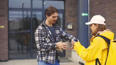 delivery person giving package to customer