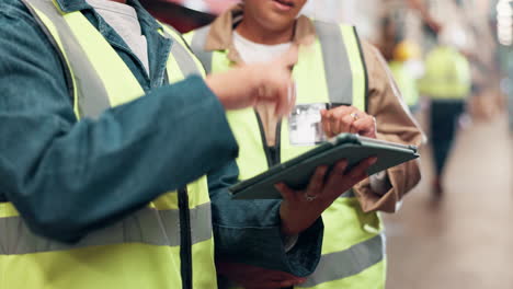 warehouse workers using a tablet for inventory management
