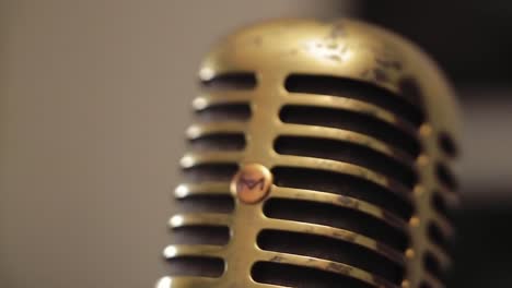 vintage microphone detail with distinctive patina reflecting the character of classic sound equipment and musical heritage in a studio setting
